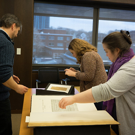 Students reviewing special collections materials in a classroom