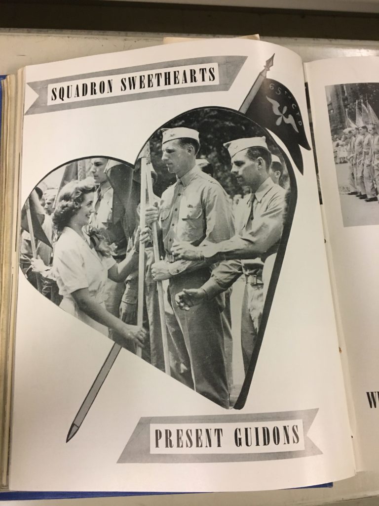 1.	Black and white page with a heart-shaped image of a woman and multiple men in uniform holding flags.