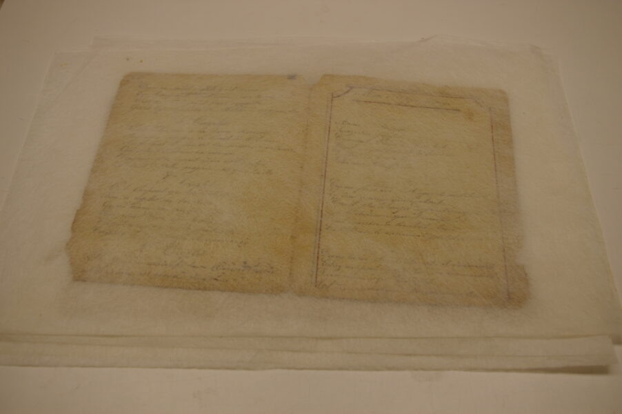Opaque sheet over manuscript pages.